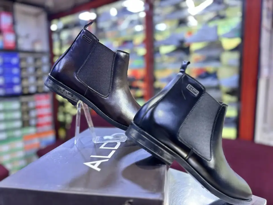 Black leather Chelsea boots on display